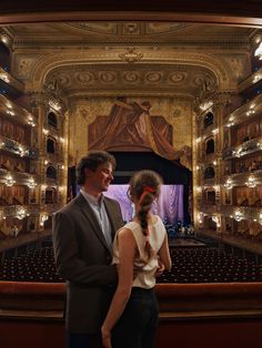 a man and woman standing in front of an auditorium