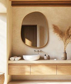 a bathroom with two sinks and a large round mirror