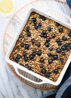 blueberry baked oatmeal in a white dish on a wire rack