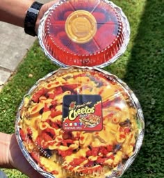 two pies that are sitting on top of each other in front of some grass