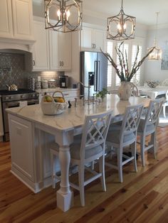 a large kitchen island with chairs around it