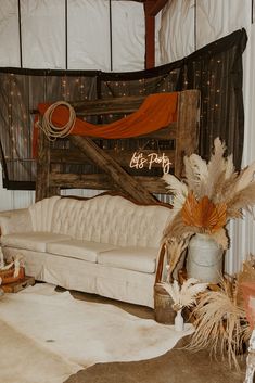 a living room filled with lots of furniture covered in orange and white decorating items