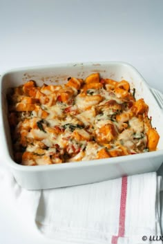 a casserole dish with cheese and spinach