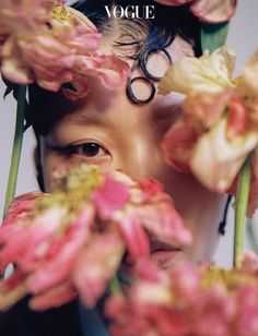 a woman with flowers in her hair and the words, volge