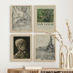 a wooden table topped with vases filled with flowers and plants next to posters on the wall