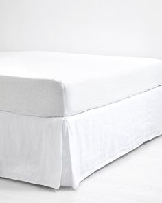 the bed is made with white linens