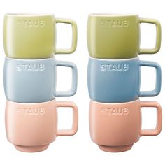 four pastel colored mugs with the word staub on each one side