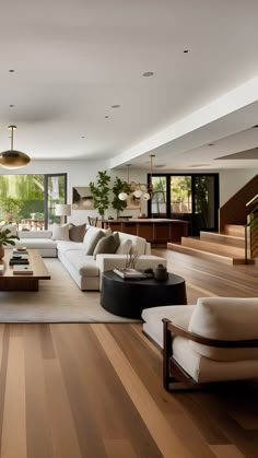 a living room filled with furniture and lots of windows