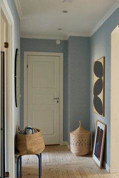 a hallway with blue walls and wooden floors