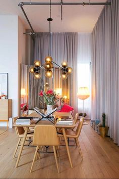 a dining room table and chairs in front of a window