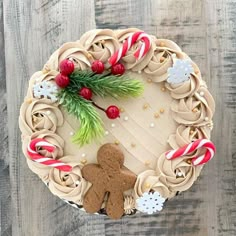 a gingerbread cake decorated with icing and candy canes