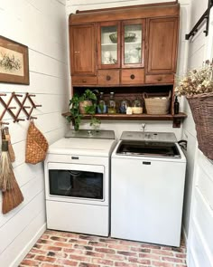 a white stove top oven sitting inside of a kitchen next to a washer and dryer