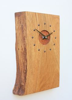 a clock made out of wood with holes in it