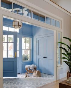 a room with blue walls and white trim on the doors is shown in this image