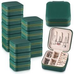 a set of six green jewelry boxes filled with lots of different items