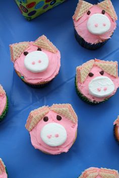 cupcakes with pink frosting decorated as pigs