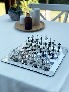 a glass chess set on top of a table