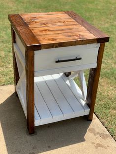 a small wooden table sitting on top of a sidewalk