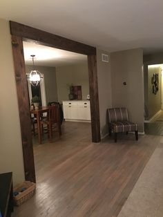 an empty living room with hard wood floors