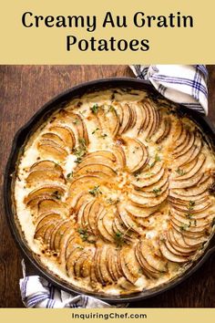 baked potato dish in a cast iron skillet on top of a wooden table with blue and white napkins