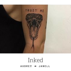 a woman with a tattoo on her arm that says trust me inked and an image of a snake