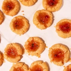 some cookies with jam on them sitting on a table