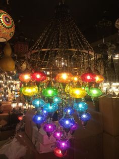 many colorful lights are hanging from the ceiling