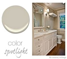 a bathroom with white paint and wood flooring next to a large mirror, sink, and toilet