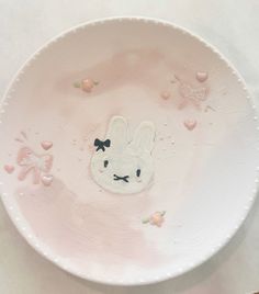 a pink plate with a bunny face on it