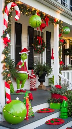 christmas decorations on the front porch of a house with grino and candy canes