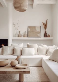 a living room filled with white furniture and decor