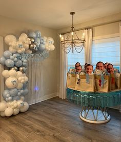 a group of people standing in front of a mirror with balloons attached to the wall