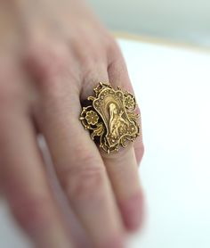 "Vintage Jewelry - Vintage Ring - St. Therese of Lisieux Ring - Catholic jewelry - Chloes Vintage Jewelry - handmade jewelry This is such a beautiful vintage ring! A vintage brass floral adjustable band with a highly detailed image of St. Therese of Lisieux holding a bouquet of flowers. Exquisite detail with a rich patina. This ring is sweet and delicate. This is a real special piece. Chloe says, Wear it and feel fabulous!\" The ring is 1 1/4\" wide. Thank you for visiting Chloe's" Holding A Bouquet Of Flowers, Saint Jewelry, Beautiful Rings Vintage, St Therese Of Lisieux, Unusual Rings, Vintage Jewelry Art, St Therese, Catholic Jewelry, Bouquet Of Flowers