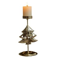 a candle holder with a christmas tree on it and a lit candle in the middle