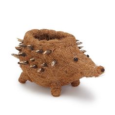 a hedgehog planter made out of straw with spikes on it's head