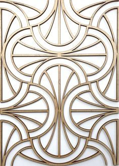 an intricate gold metal design on a white wall