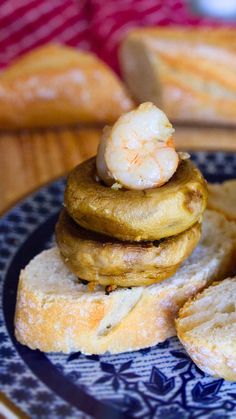 some food is on a blue and white plate with bread in the backgroud