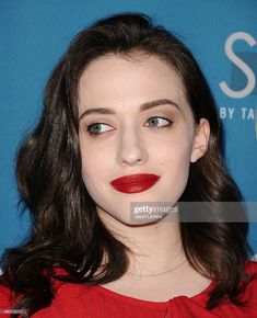 a young woman with dark hair and red lipstick