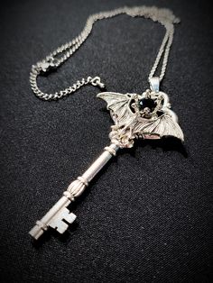 Key Necklace Vampire Bat With Black Crystal Gothic jewelry accessory, beautiful gift for many occasions: party, ball, wedding, date, cosplay event... Big silver plated key with little vampire bat and a black Swarovski crystal. Size of the pendant: 9 cm Size of the chain: 70 + 5 cm Vampire Items, Vampire Accessories, Imp Oc, Necklace Vampire, Gothic Necklaces, Key Necklaces, Vampire Necklace, Vampire Jewelry, Witchy Style