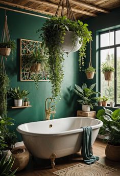 a bathroom with green walls and plants hanging from the ceiling, along with a white bathtub