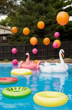 an inflatable pool with flamingos and floating balls