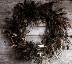 an old wooden chair with a wreath on the wall