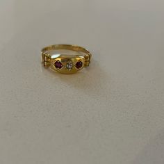 Antique 18k Garnet Diamond Gypsy Ring From Birmingham C 1901. This Yellow Gold Edwardian Ring Features Two Round Cut Garnets And One European Cut Diamond In A Marquis Setting. The Shoulders Of This Antique Ring Have A Columnar Architecture To Them. Ring Is Sized To 6 3/4; There Is A 18k Stamp Inside. Antique Multi-stone Yellow Gold Cluster Ring, Antique Multi-stone Cluster Ring In Yellow Gold, Formal Yellow Gold Three Stone Rings, Victorian Multi-stone Yellow Gold Diamond Ring, Antique 14k Gold Ruby Ring With Multi-stone, Classic Yellow Gold Three Stone Ruby Ring, Classic Three Stone Ruby Ring In Yellow Gold, Classic Three Stone Yellow Gold Ruby Ring, Victorian Ruby Ring In Stamped 14k Yellow Gold