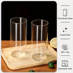 two glasses sitting on top of a wooden cutting board