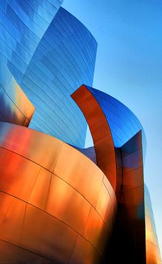 an orange and blue building with a large curved design on it's front side