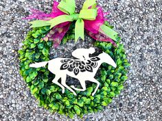 a wreath with a horse and flowers on it