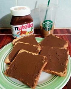 four pieces of peanut butter and jelly sandwich on a plate with a cup of coffee