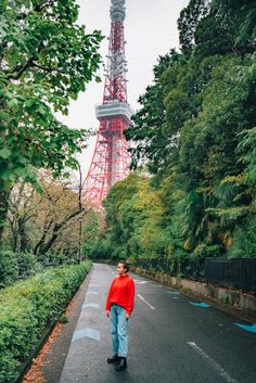 a man is walking down the street in front of the eiffel tower