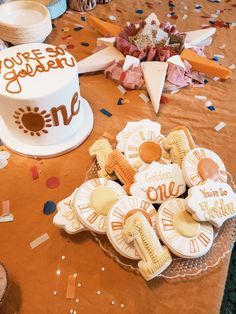 a table topped with lots of cookies and confetti