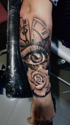 a person with a clock and rose tattoo on their arm